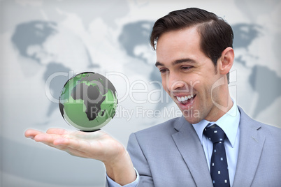 Content businessman admiring a green globe