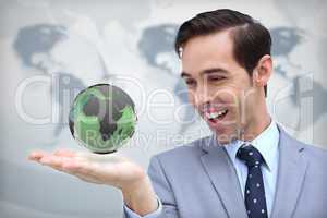 Content businessman admiring a green globe