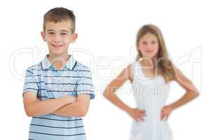 Cheerful child posing with his sister on background