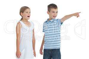 Young boy showing something to his sister