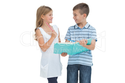 Smiling brother and sister learning their lesson together