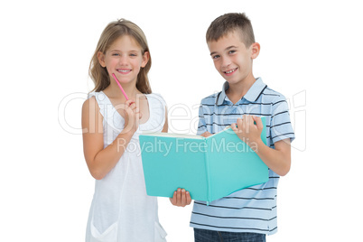 Cheerful brother and sister learning their lesson together