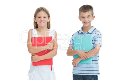 Cheerful brother and sister holding their exercise books