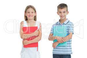 Cheerful brother and sister holding their exercise books