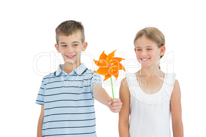 Brother and sister playing with pinwheel