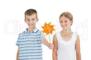 Brother and sister playing with pinwheel