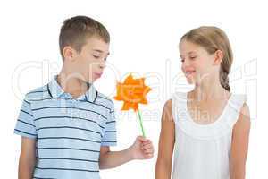 Peaceful brother and sister playing with pinwheel
