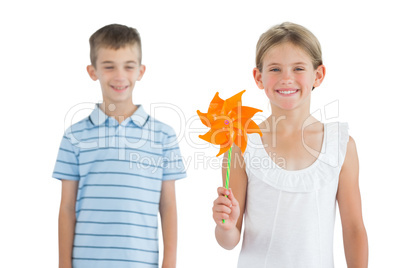 Happy brother and sister playing with pinwheel