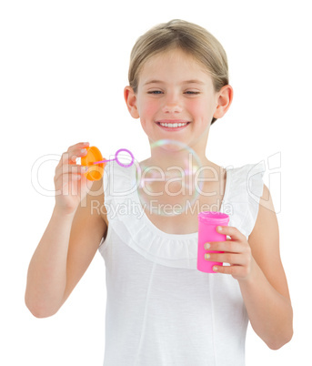 Smiling girl making bubbles