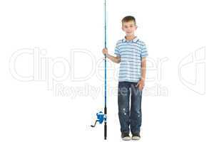 Smiling young boy holding fishing rod