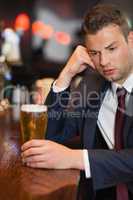 Pensive businessman having a drink