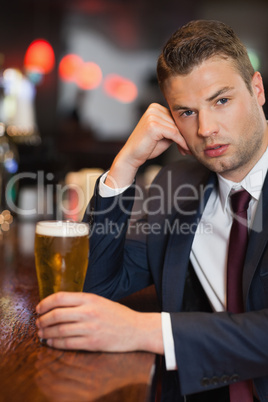 Worried businessman having a drink