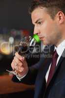 Businessman tasting red wine