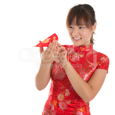 Chinese cheongsam girl peeking into red packets