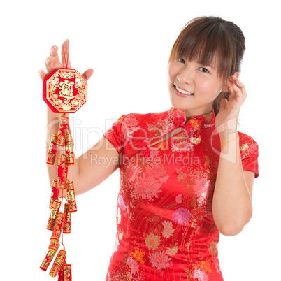 Chinese cheongsam girl holding fire crackers