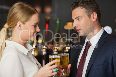 Colleagues clinking their glasses of beer