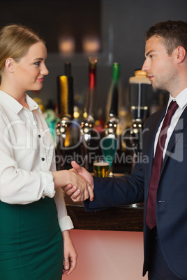 Cheerful colleagues shaking hands Cheerful colleagues shaking hands