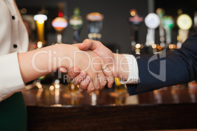Close up on colleagues shaking hands