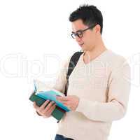 Asian adult student reading book