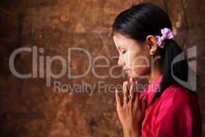 Myanmar girl in a praying pose.