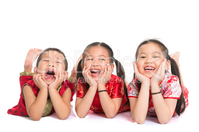 Asian children lying on floor