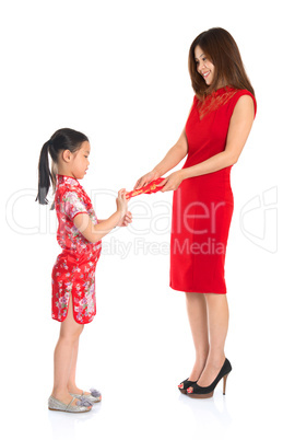 Asian Chinese child receiving monetary gift from parent