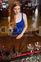 Mysterious attractive woman having a flute of champagne