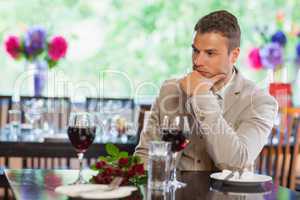 Handsome man waiting for his girlfriend at restaurant