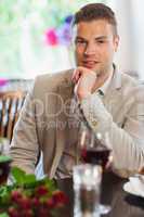 Smiling handsome man waiting for his girlfriend at restaurant
