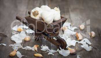 garlic cloves in a miniature wheelbarrow