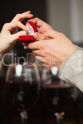 Close up on a woman taking the ring during marriage proposal