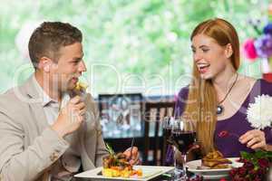 Cheerful couple eating together