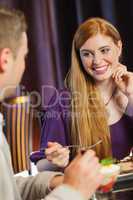 Gorgeous woman smiling at her husband during dinner