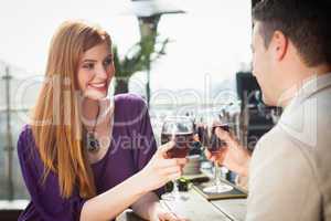 Cheerful couple having glass of wine together