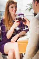 Smiling couple having glass of wine together