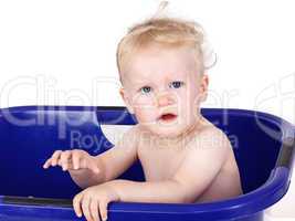 Toddler sitting in the bathtub