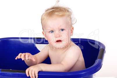 Toddler sitting in the bathtub