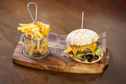 Close up on a cheese burger and french fries