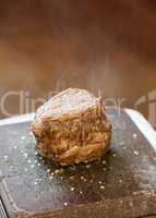 Steak sizzling on hot stone plate