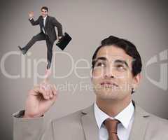 Businessman showing shrunk colleague dancing on his finger