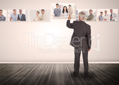 Businessman selecting business people digital interface