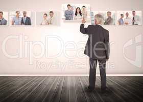 Businessman selecting business people digital interface