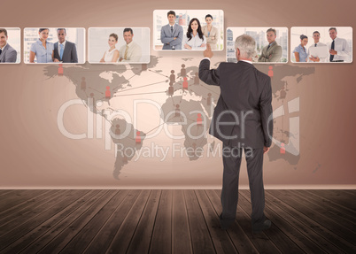 Businessman selecting digital interface with map on background