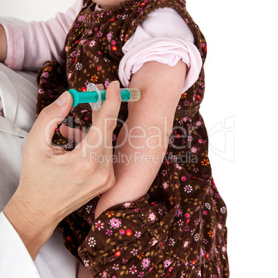 Doctor injects small child in her arms