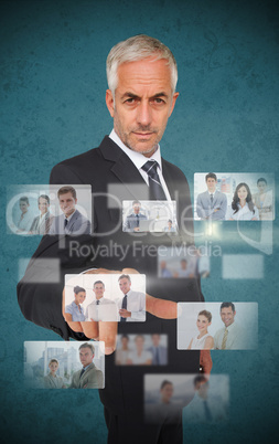 Mature stylish businessman using futuristic interface