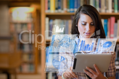 Pretty student working on her futuristic tablet