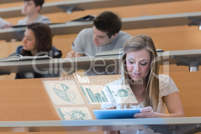 Pretty blonde student in university working on her futuristic ta
