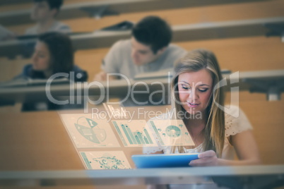 Pretty student analysing graphs on her digital tablet