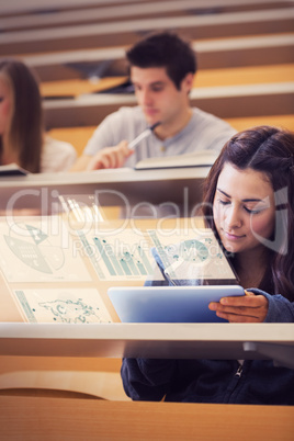 Student analysing graphs on her digital tablet computer