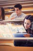 Student analysing graphs on her digital tablet computer